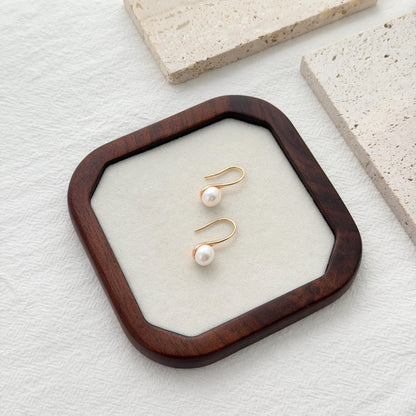 Freshwater pearl hook earrings crafted in gold over sterling silver with delicate organic shape