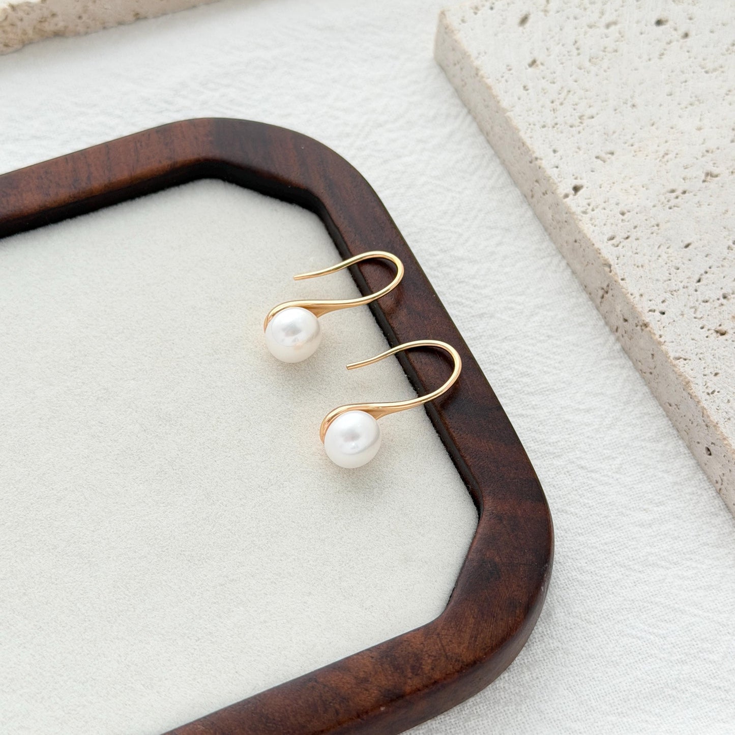 Elegant freshwater pearl earrings in curved gold setting with lightweight everyday design