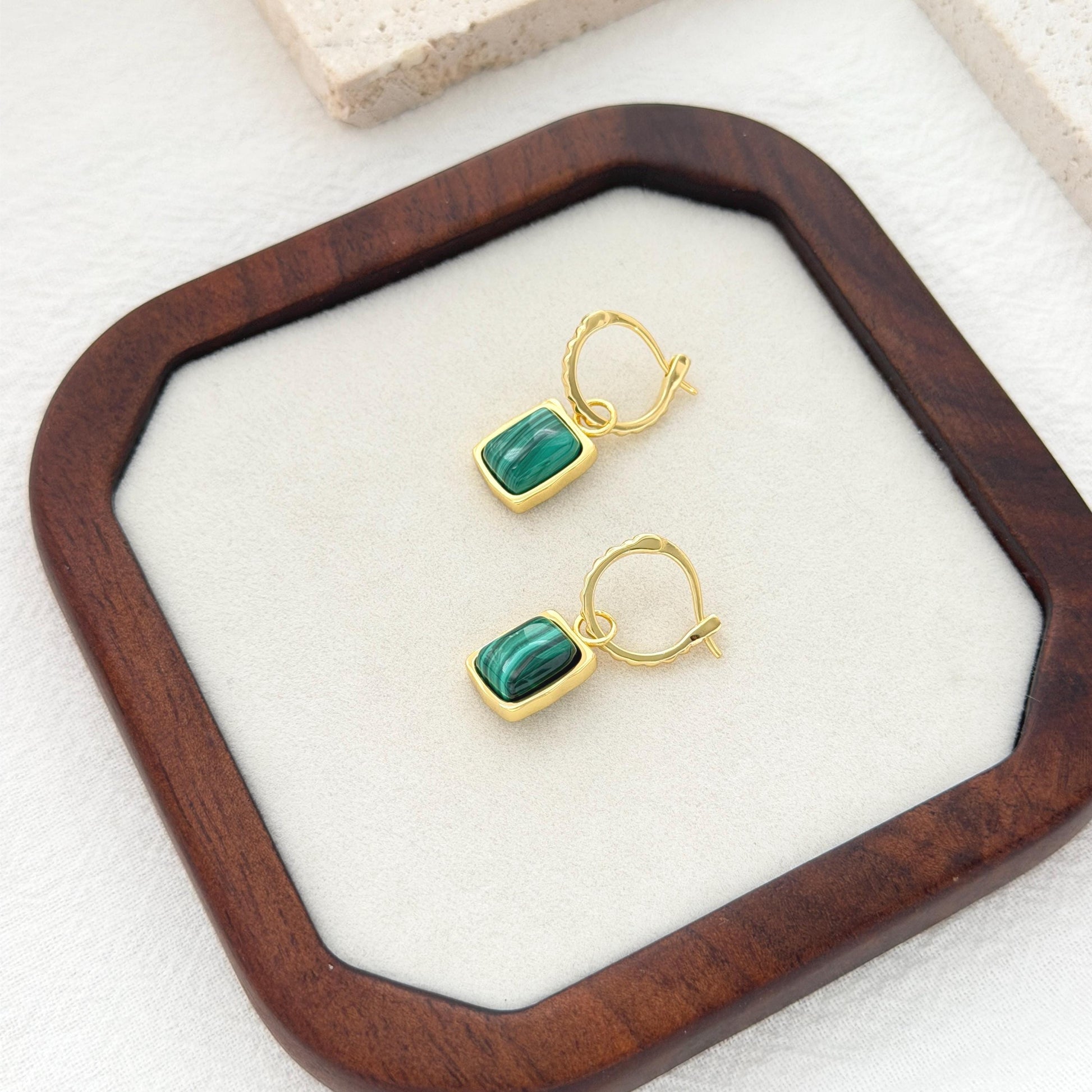Green malachite hoop earrings with rectangular stone pendants and textured gold hoop design