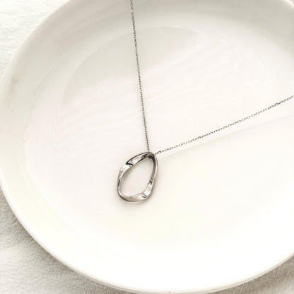 Organic silver necklace with modern oval pendant and elegant everyday styling 