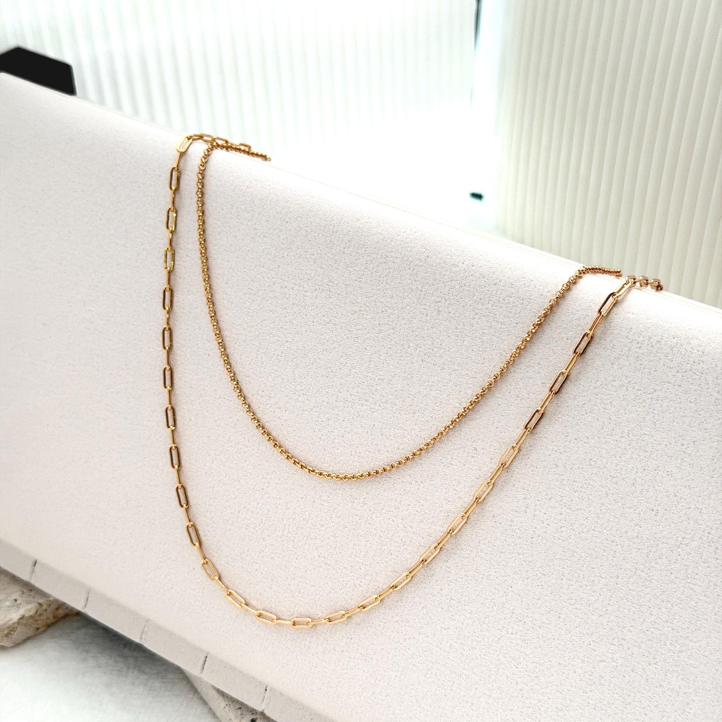 Gold layering necklace featuring mixed chain textures and elegant modern silhouette
