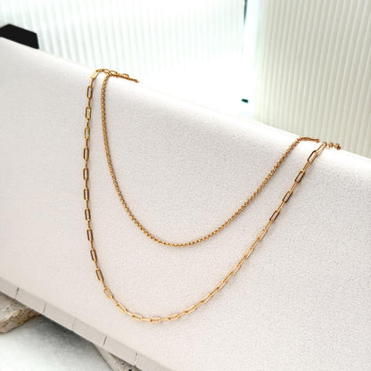 Gold layering necklace featuring mixed chain textures and elegant modern silhouette
