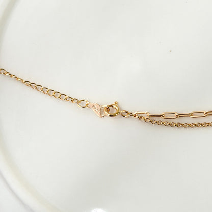 Everyday gold necklace with layered chains and refined minimalist aesthetic