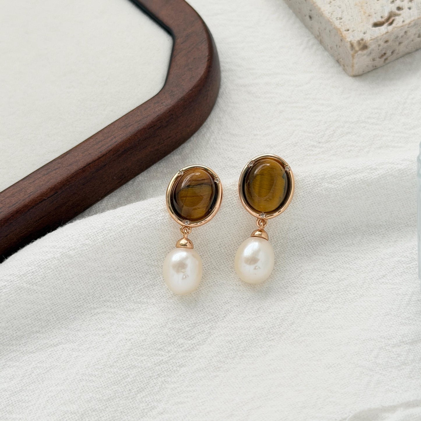 Vintage tiger’s eye drop earrings with natural freshwater pearls and warm gold settings.