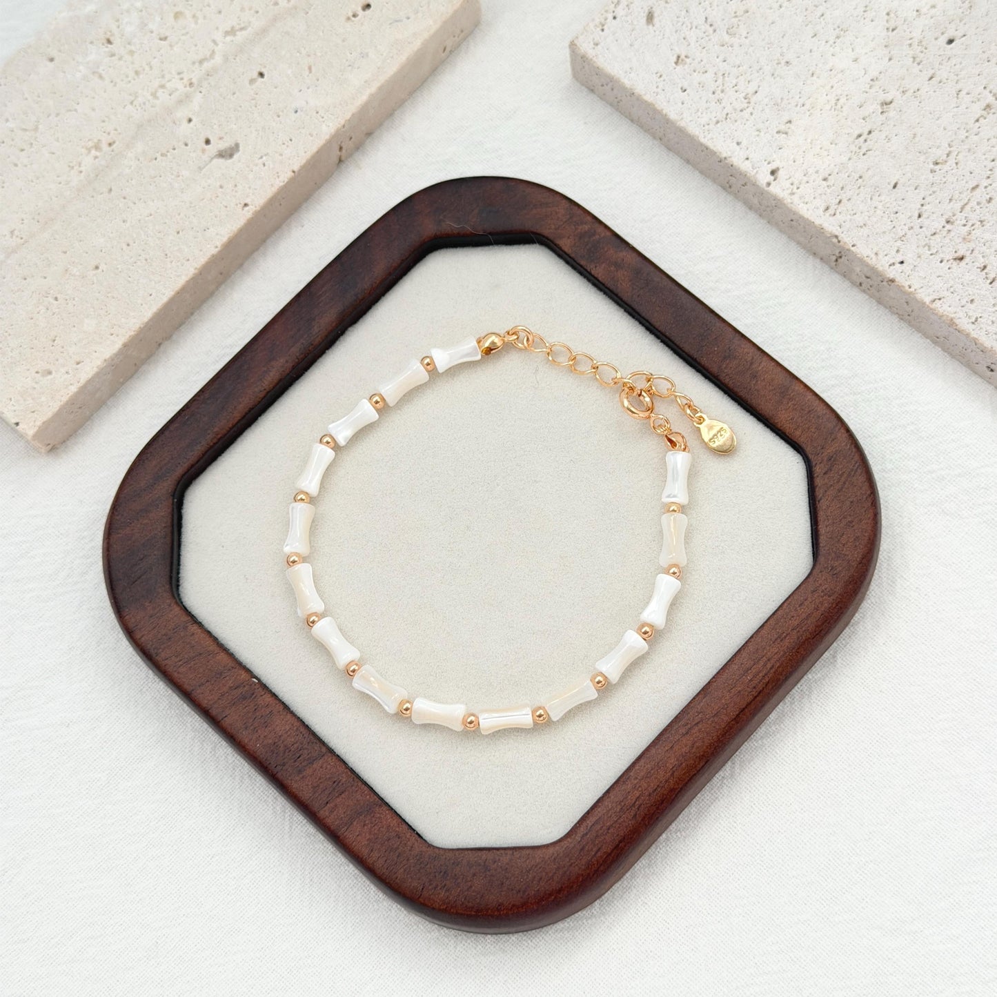 White shell bead bracelet with gold accent beads and adjustable gold extender chain