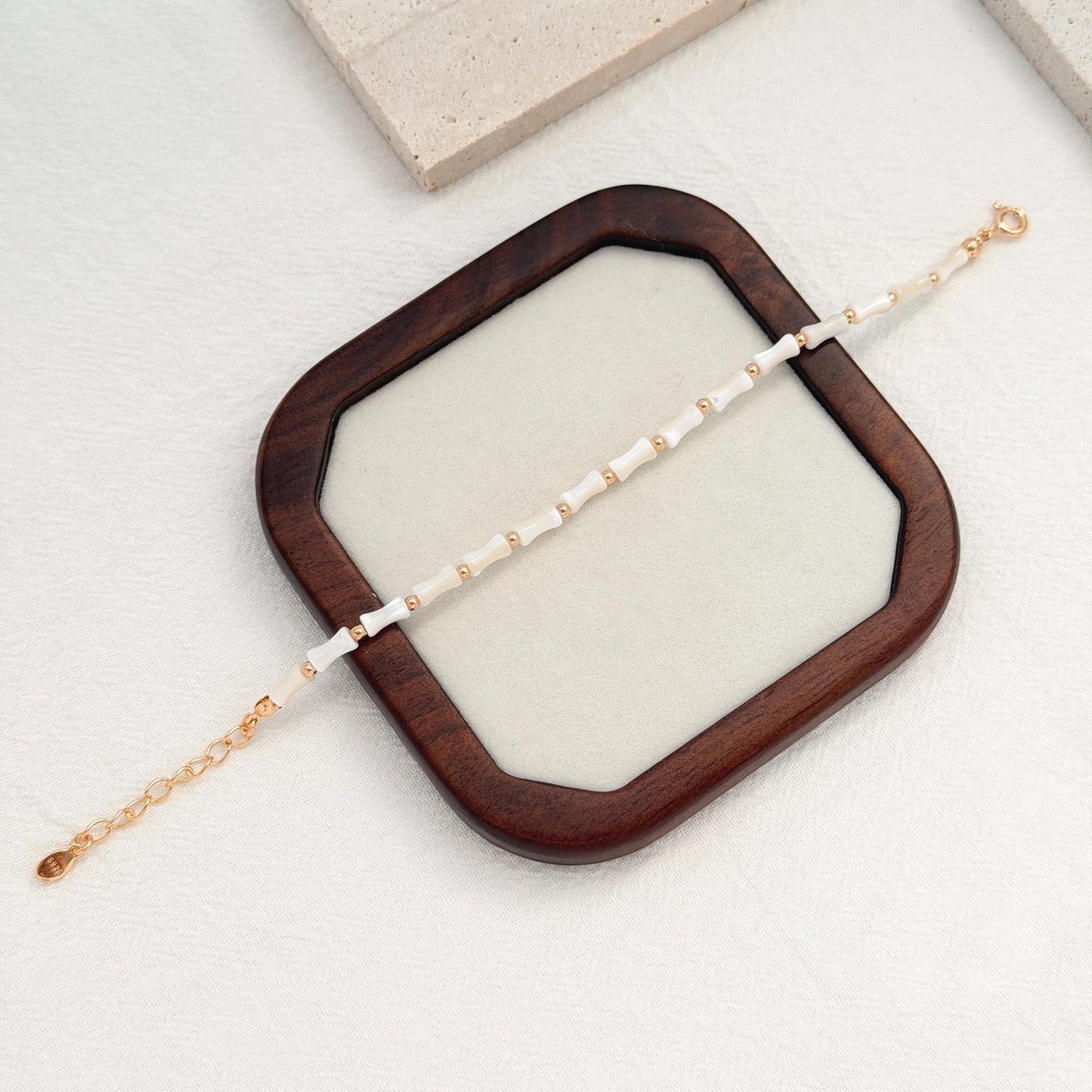 Ocean-inspired white shell bracelet with dainty gold beads and a delicate adjustable clasp