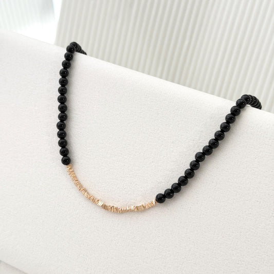 Black agate bead necklace with delicate gold details