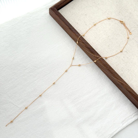 Minimal gold bead chain necklace with dainty oval accents