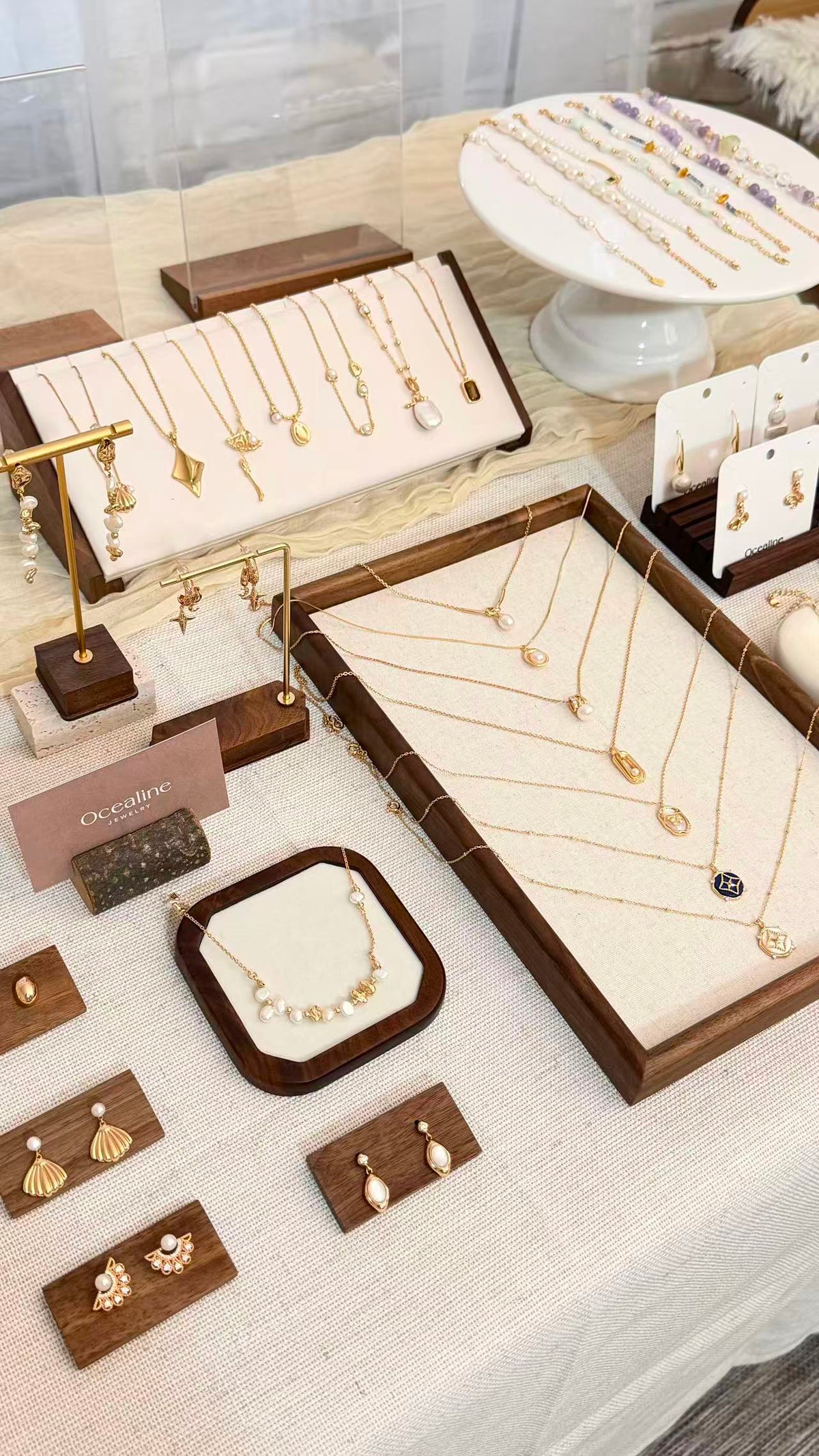 Ocealine baroque freshwater pearl jewelry display at a NYC pop-up featuring pearl necklaces, pearl earrings, bracelets, gold jewelry, and sterling silver jewelry.