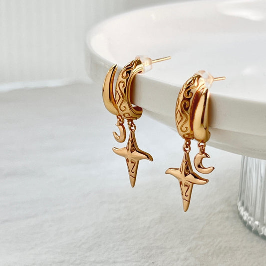 Detail of clasp and chain on 18K vintage gold star celestial dangling earrings, dainty minimalist jewelry.